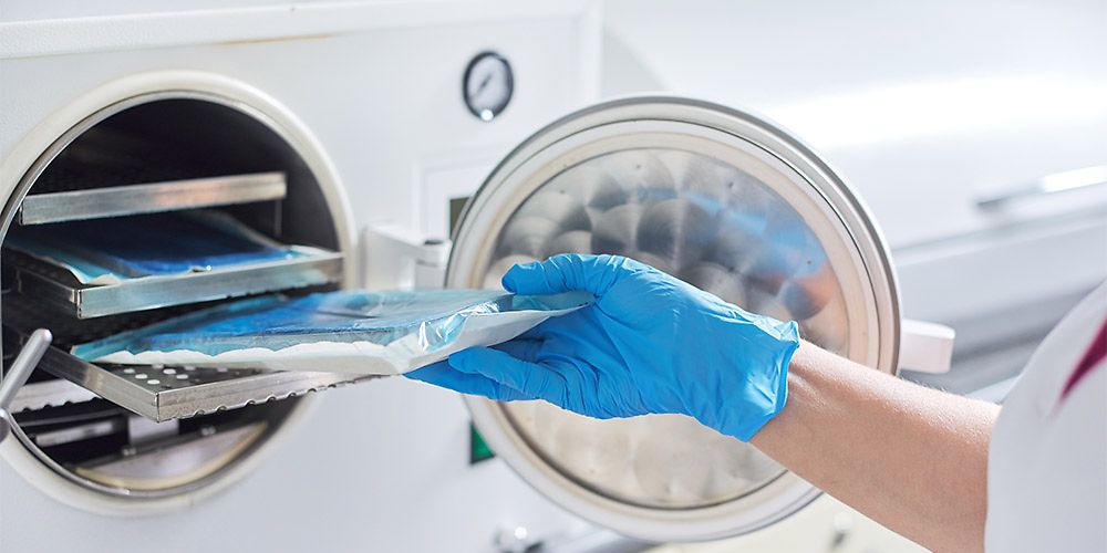  02_Nurse_doing_sterilization_AdobeStock_318631273_web